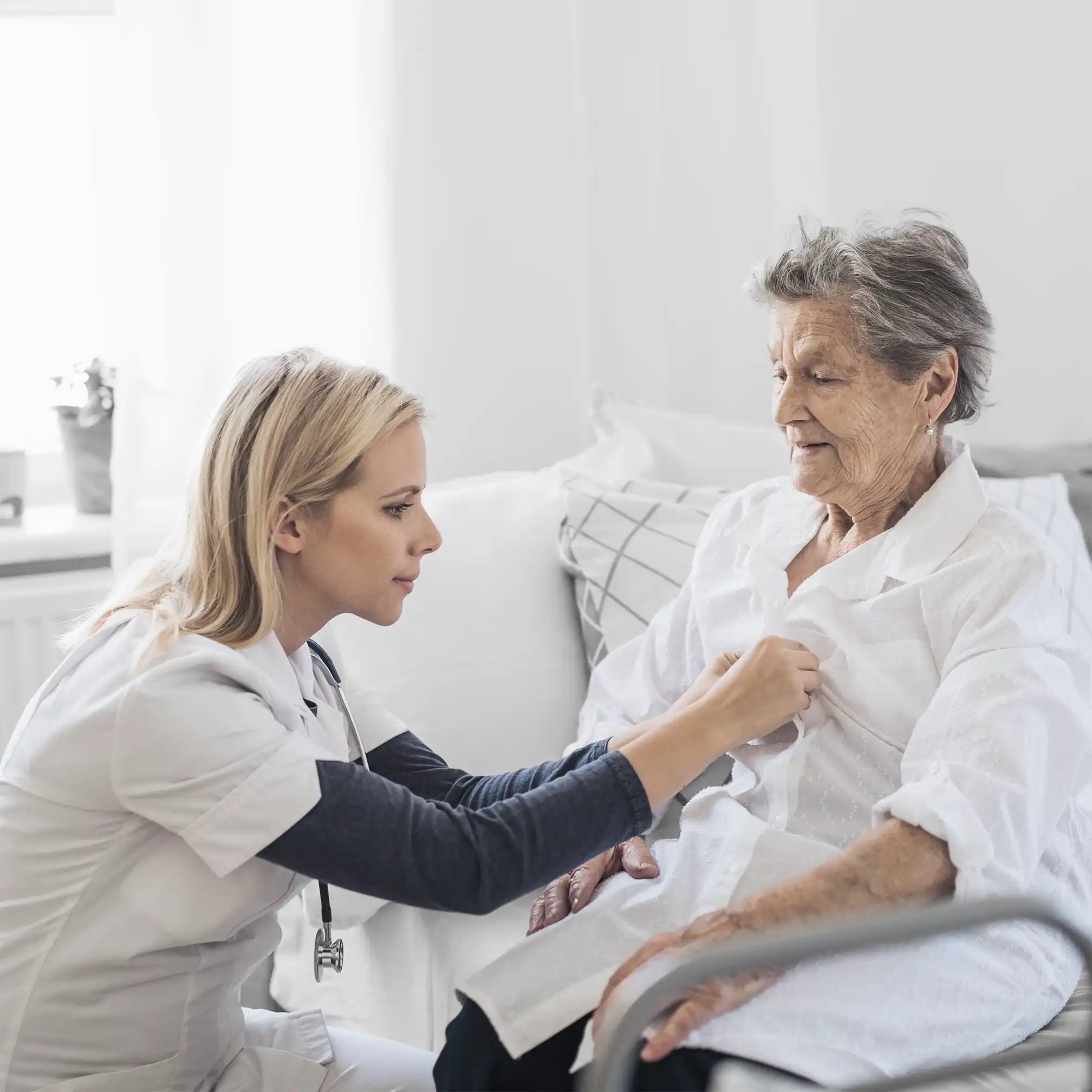 Nurse checking patients breathing with stethoscope