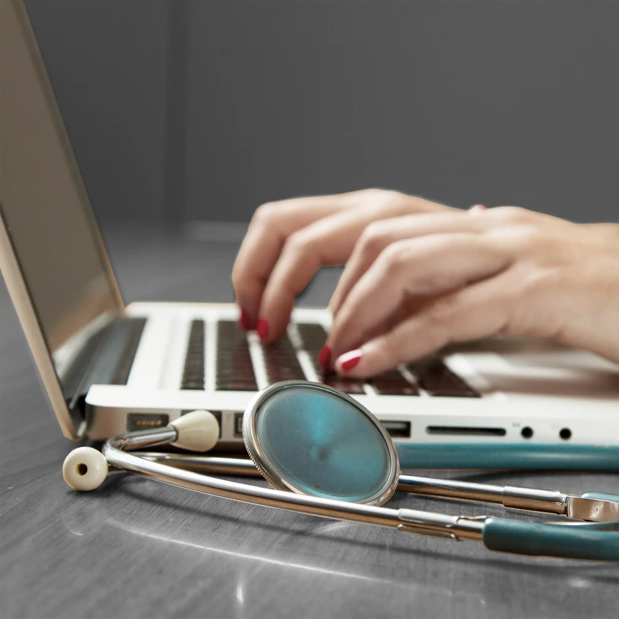 Close up of hands typing on a laptop
